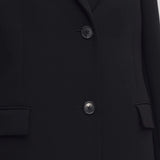 Middle closeup view of black cerys coat on model against a white background.