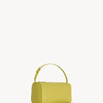 Side slanted view of coppery yellow leather bag on white background, with no model shown.