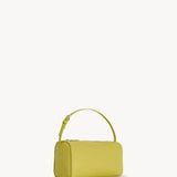 Side slanted view of coppery yellow leather bag on white background, with no model shown.