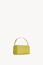 Side slanted view of coppery yellow leather bag on white background, with no model shown.