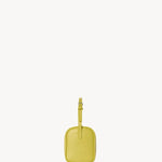 Side view of coppery yellow leather bag on white background, with no model shown.