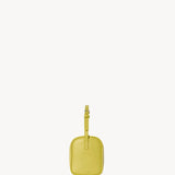Side view of coppery yellow leather bag on white background, with no model shown.