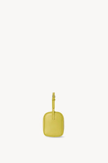 Side view of coppery yellow leather bag on white background, with no model shown.