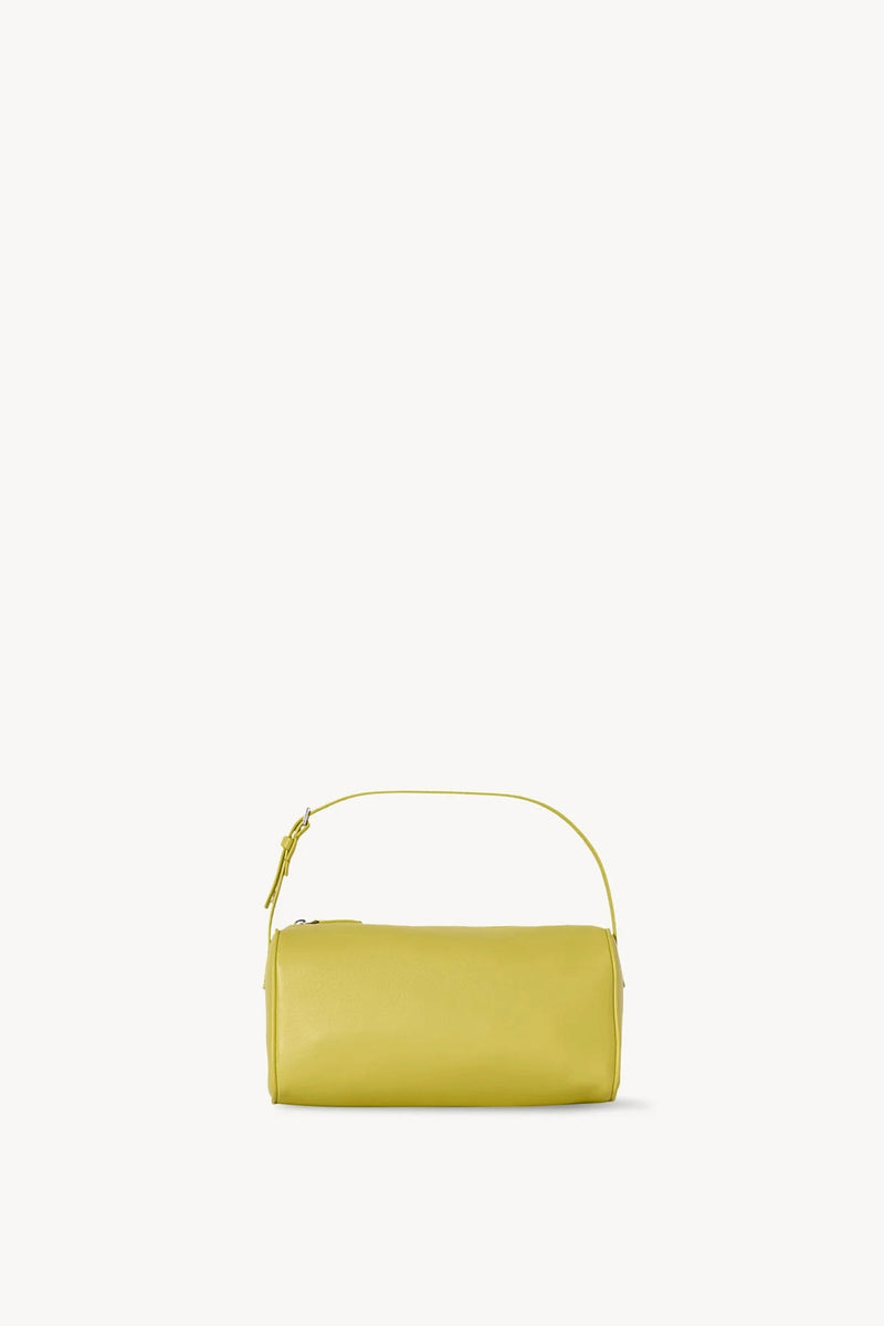 Front view of coppery yellow leather bag on white background, with no model shown.