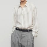Front view of grey stripe shirt on model wearing grey trousers, against a white background.