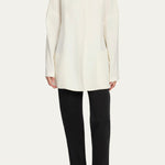 Front view of off white elke jacket on model wearing black pants and ballet flats, against a white background.