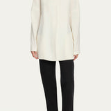 Front view of off white elke jacket on model wearing black pants and ballet flats, against a white background.