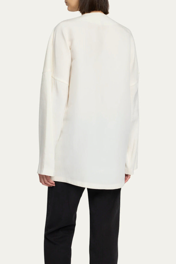 Back view of off white elke jacket on model wearing black pants, against a white background.