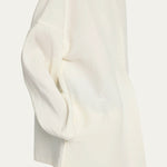 Side view of off white elke jacket on model wearing black pants, against a white background.