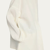 Side view of off white elke jacket on model wearing black pants, against a white background.