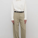 Front view of fossil elowyn pant on model wearing white shirt and black heels, against a white background.
