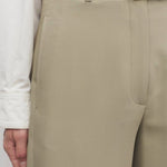 Front closeup view of fossil elowyn pant on model wearing white shirt, against a white background.