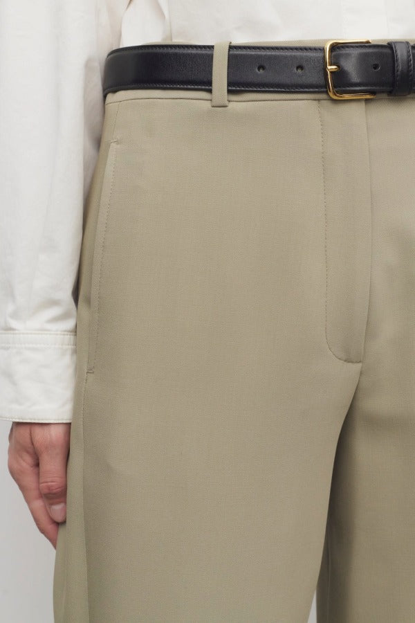 Front closeup view of fossil elowyn pant on model wearing white shirt, against a white background.