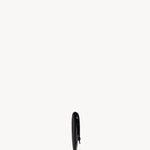 Side view of black envelope clutch on white background, with no model shown.