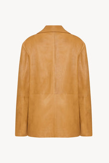 A caramel colored lambskin leather jacket, shown back facing without model.