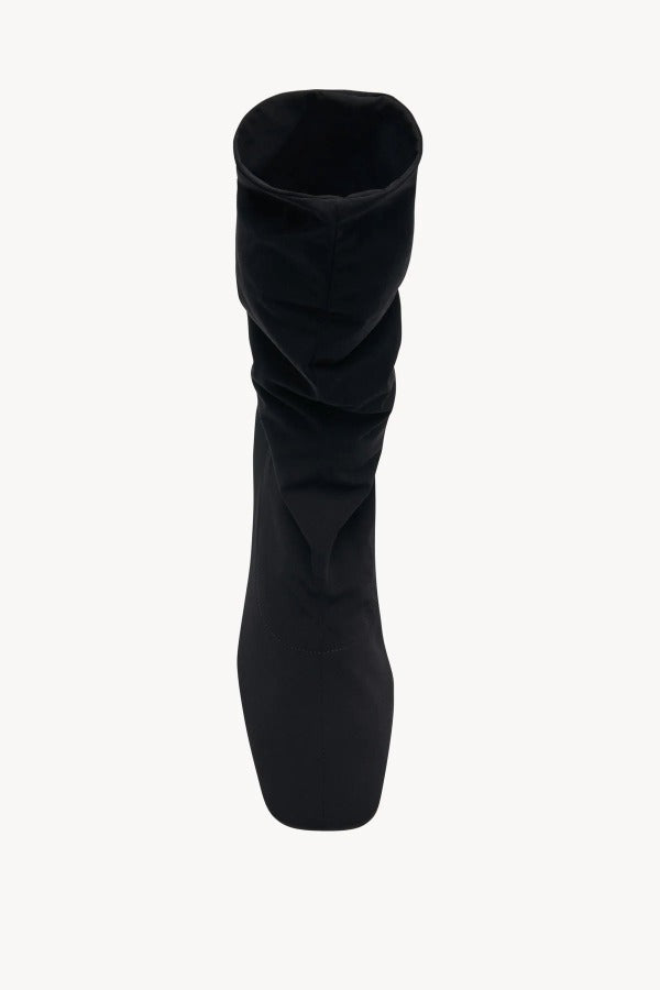 Overhead view of black felice strech boot on white background, with no model shown.