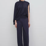 Front view of navy gala pant on model wearing black top and mules, against a white background.