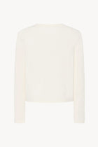 A long-sleeved white cotton button-down sweater is displayed from the back against a plain white background, without a model.
