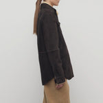 Side view of dark brown gwena jacket on model wearing khaki pants, against a white background.