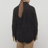 Back view of dark brown gwena jacket on model wearing khaki pants, against a white background.