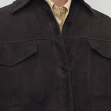 Front closeup view of dark brown gwena jacket on model wearing yellow shirt, against a white background.