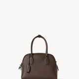Front view of deep brown india 10 bag on white background, with no model shown.