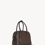 Front slanted view of deep brown india 10 bag on white background, with no model shown.