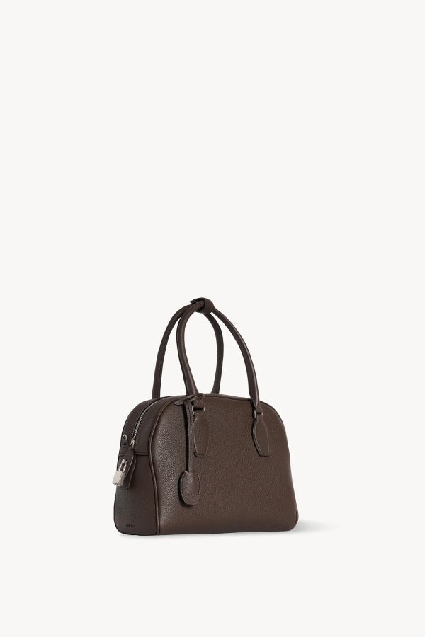 Front slanted view of deep brown india 10 bag on white background, with no model shown.