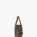 Side view of deep brown india 10 bag on white background, with no model shown.
