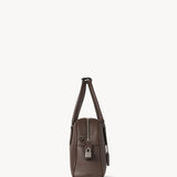 Side view of deep brown india 10 bag on white background, with no model shown.