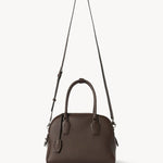 Strap view of deep brown india 10 bag on white background, with no model shown.