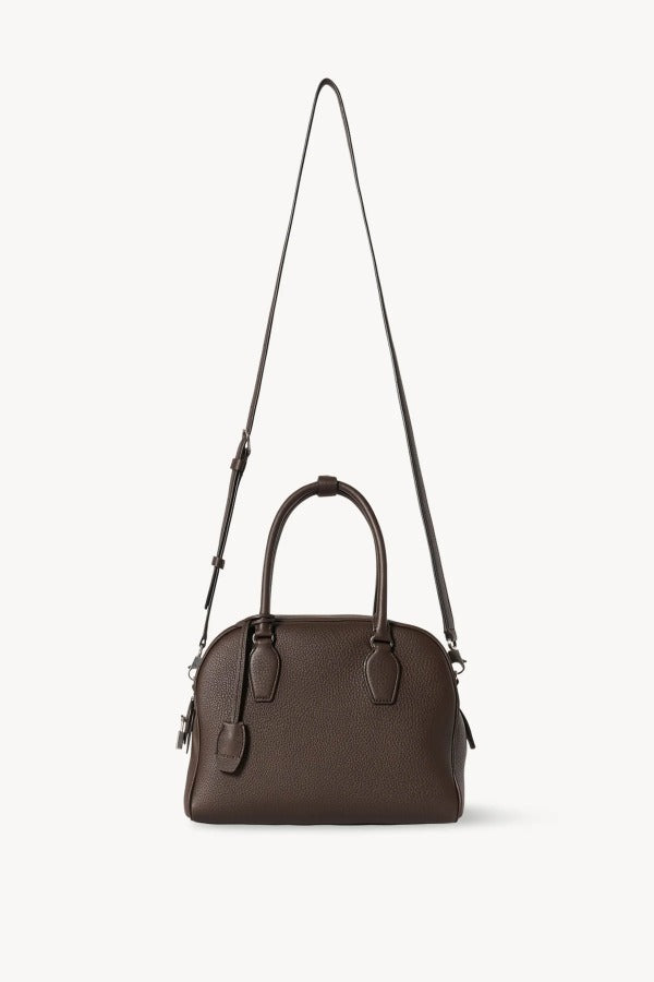 Strap view of deep brown india 10 bag on white background, with no model shown.