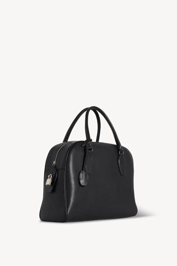 Front slanted view of black india 12 bag on white background, with no model shown.