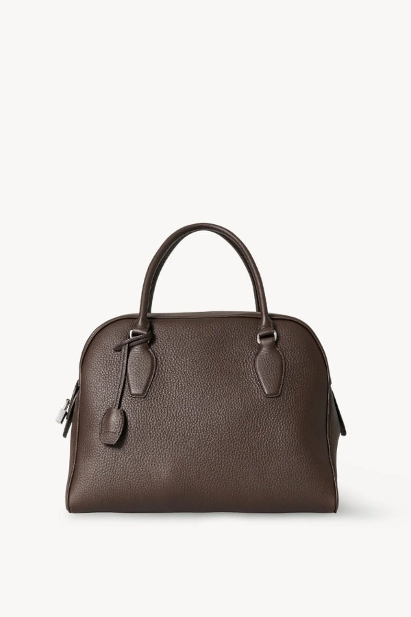 Front view of deep brown india 12 bag on white background, with no model shown.