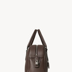 Side view of deep brown india 12 bag on white background, with no model shown.