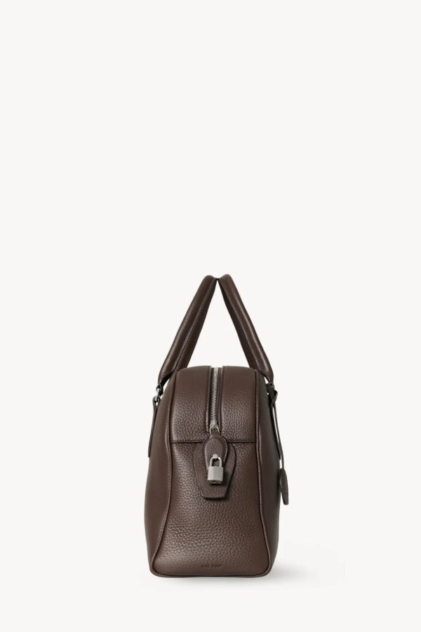Side view of deep brown india 12 bag on white background, with no model shown.