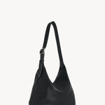 Back view of black isa shoulder bag on white background, with no model shown.