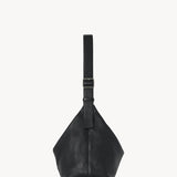 Side view of black isa shoulder bag on white background, with no model shown.