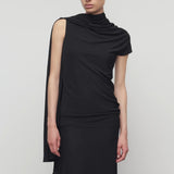 Front view of black isadra top on model wearing black skirt, against a white background.