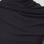 Front closeup view of black isadra top on model, against white background.