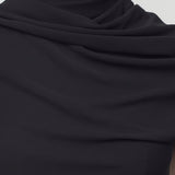 Front closeup view of black isadra top on model, against white background.