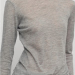 Front closeup view of grey melange iverness top on model wearing grey sweatpants, against a white background.