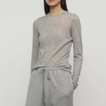 Front view of grey melange iverness top on model wearing grey sweatpants, against a white background.