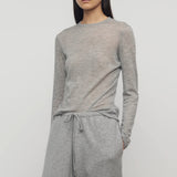 Front view of grey melange iverness top on model wearing grey sweatpants, against a white background.