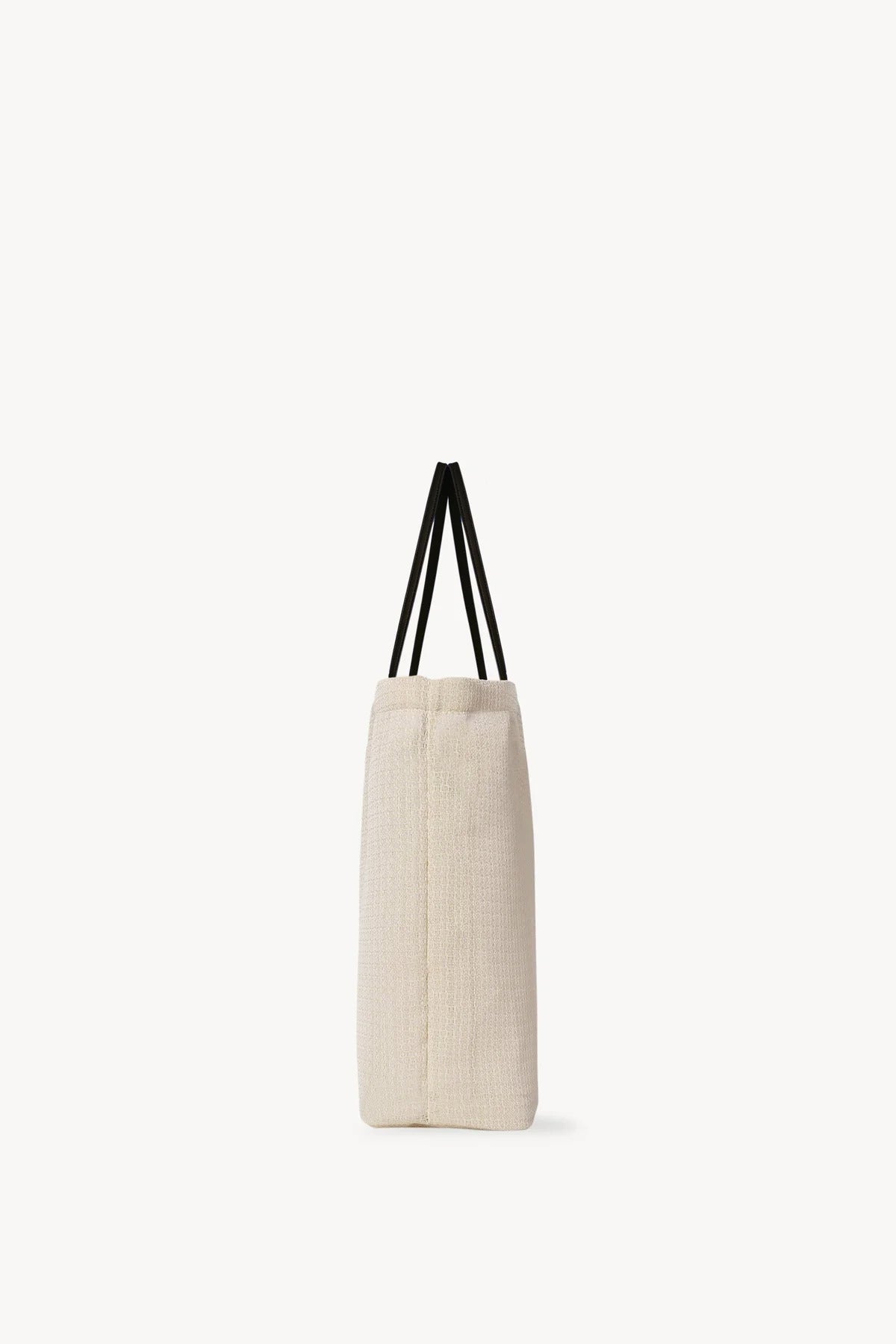 Side view of the ivory mesh and leather bag is pictured on a white background, with no model shown.