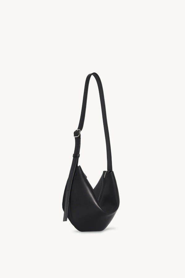 Front slanted view of black jouvette bag on white background, with no model shown.