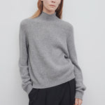 Front view of medium heather grey kensington top on model wearing black trousers, against a white background.
