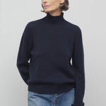Front view of dark navy kensington top on model wearing jeans, against a white background.