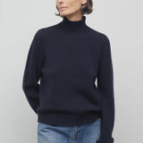 Front view of dark navy kensington top on model wearing jeans, against a white background.