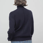 Back view of dark navy kensington top on model wearing jeans, against a white background.